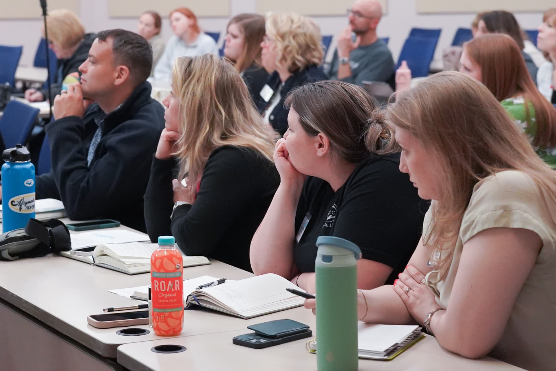 TLC members taking notes during a session