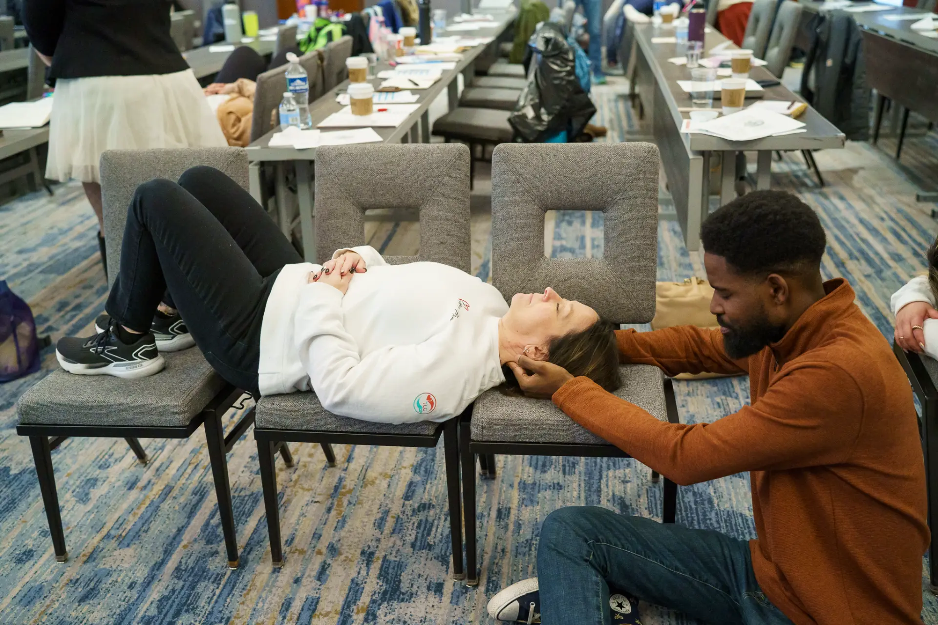 TLC members practicing a hands-on adjustment during a session