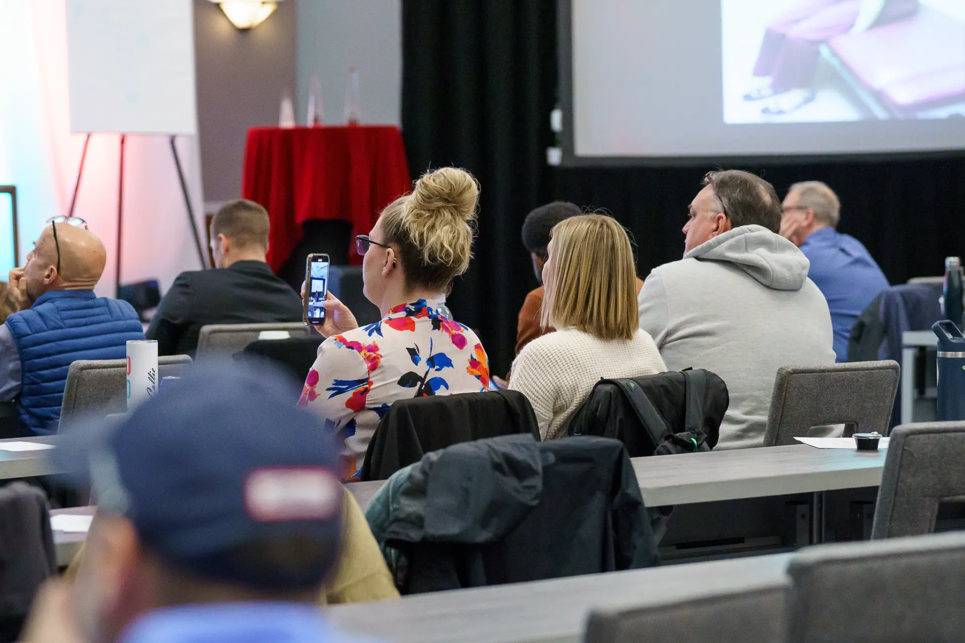 TLC members watching a session, one capturing a photo