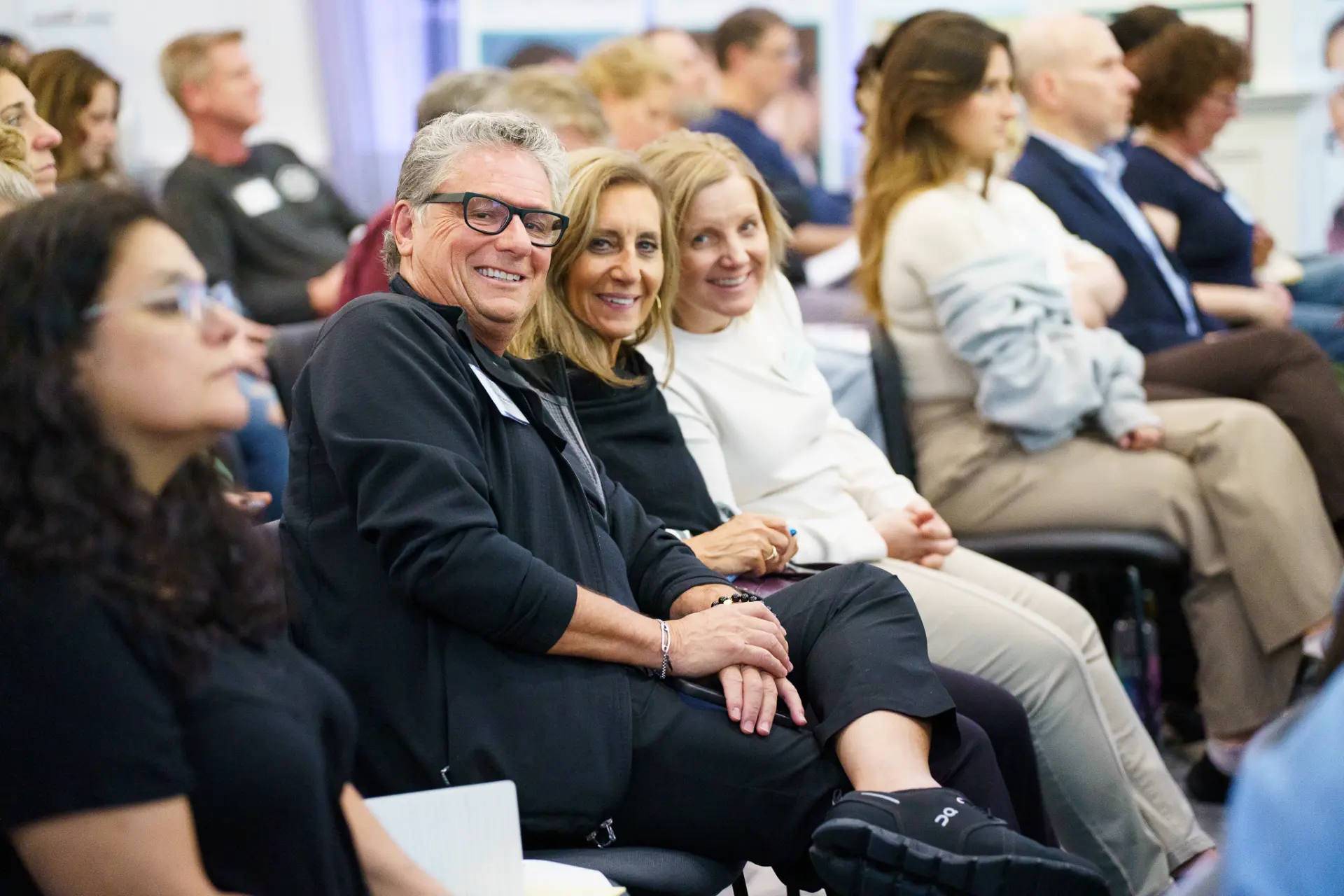 TLC members seated together at a live event