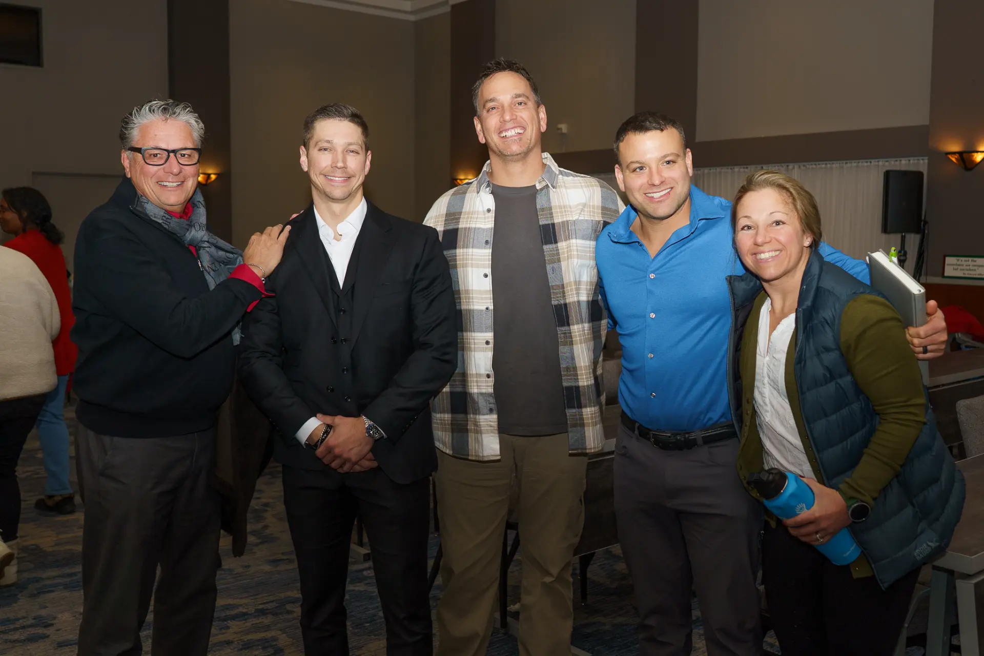 Five TLC members smiling together at an event