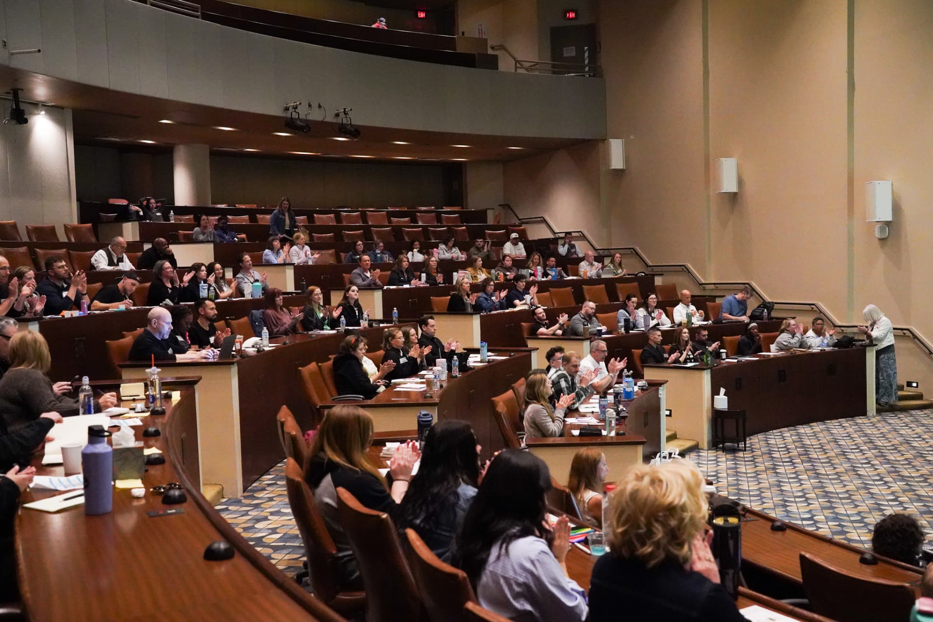 TLC members applauding during a live seminar