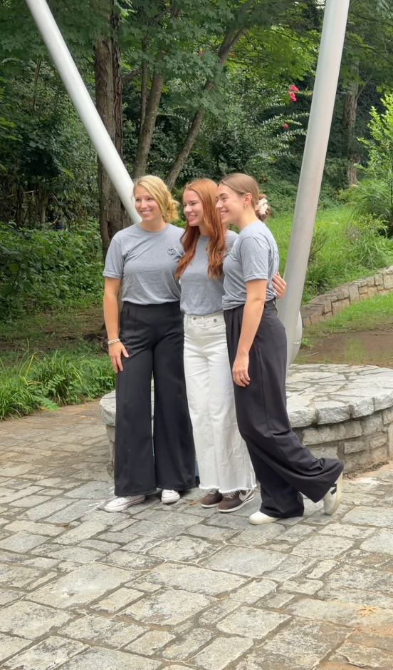 Three students smiling together on the Life University campus