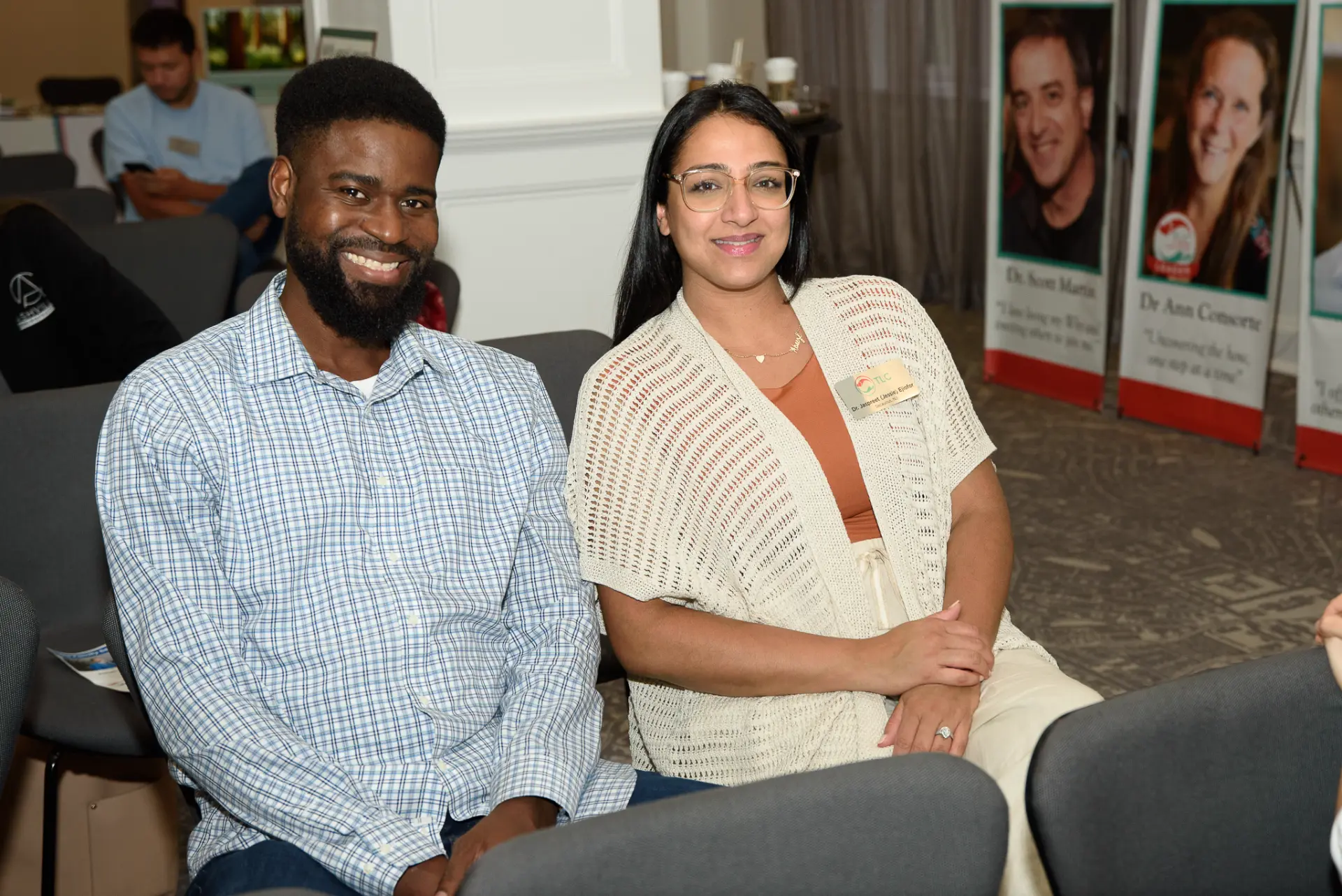Two TLC members seated together at an event