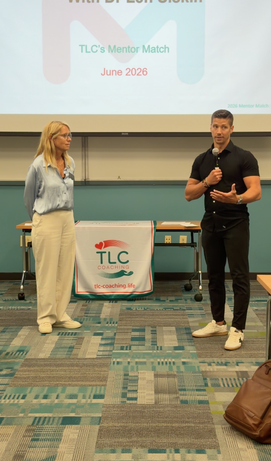 TLC coaches speaking at the front of a classroom at Mentor Match