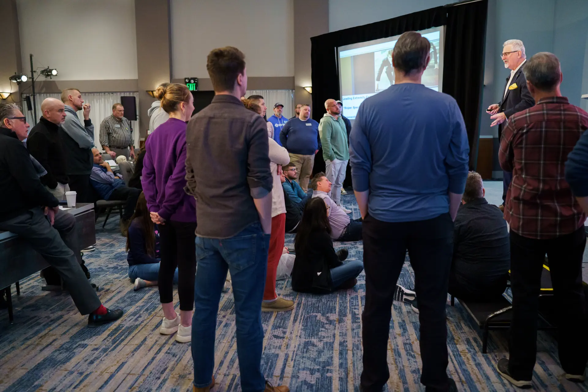 TLC members gathered around a speaker during a demonstration