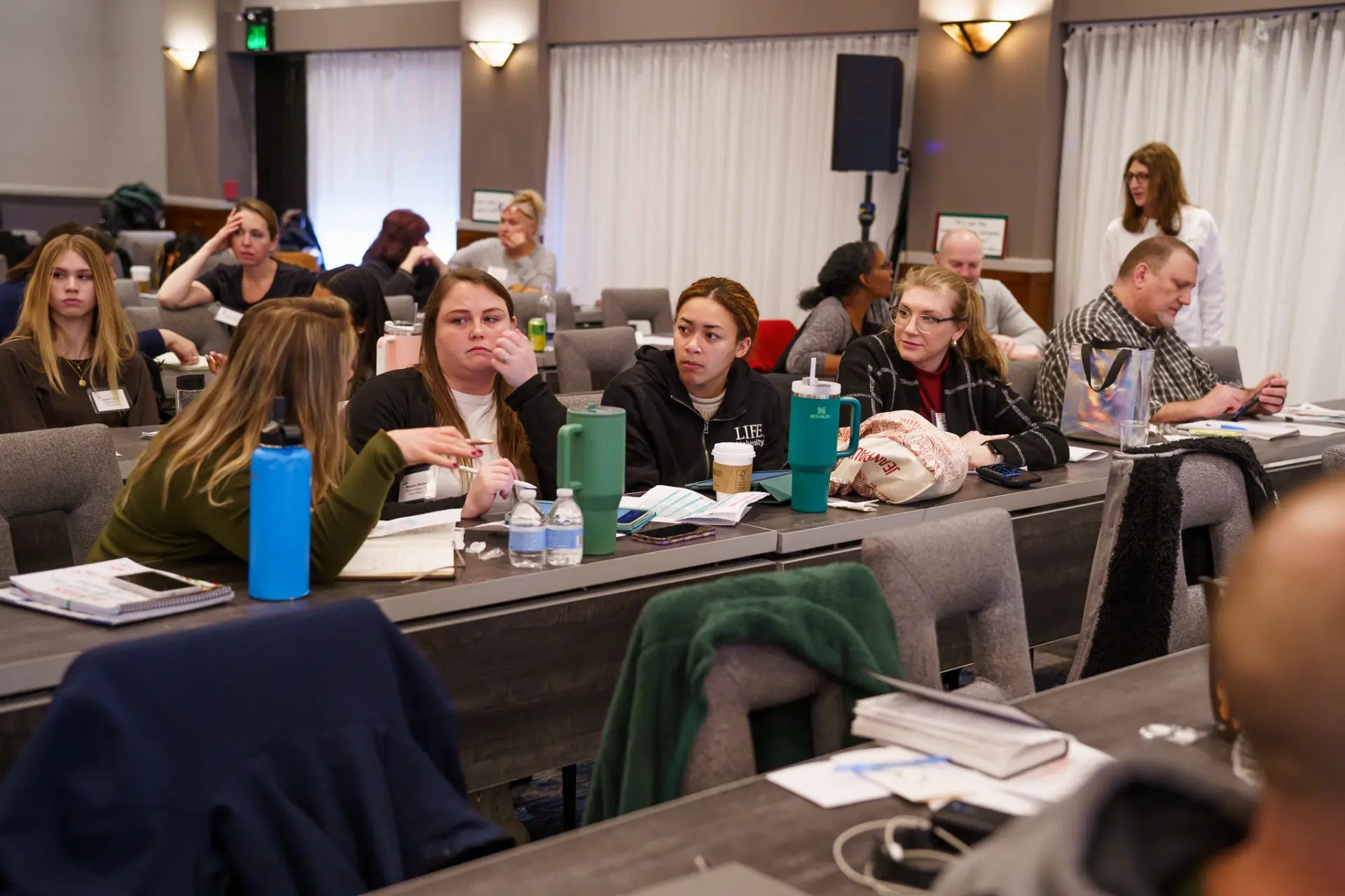 TLC members in discussion at seminar tables