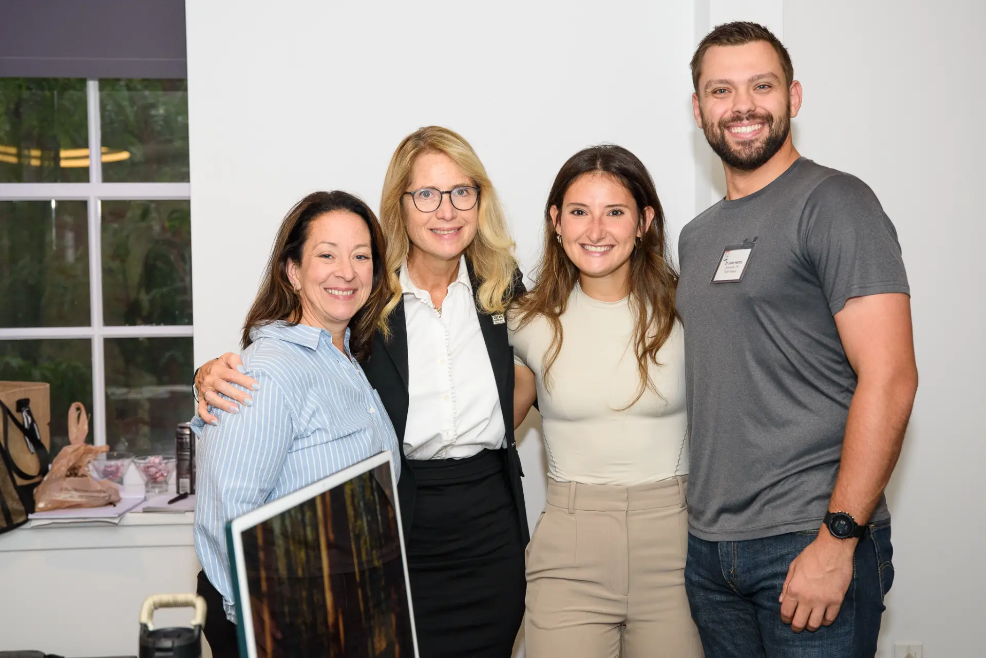 Four TLC members smiling together at an event